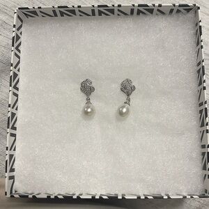 Dangling pearl earring. Missing one teeny tiny stone. Barely noticeable.